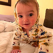 Parker joined the competition — help win amazing prizes! baby, child, infant, crawling, hooded_outfit, pajamas, animal_print, wide_eyed, smiling, portrait, indoors, bedroom, bed, bedding, pillows, blanket, couch, warm_lighting, photography, face