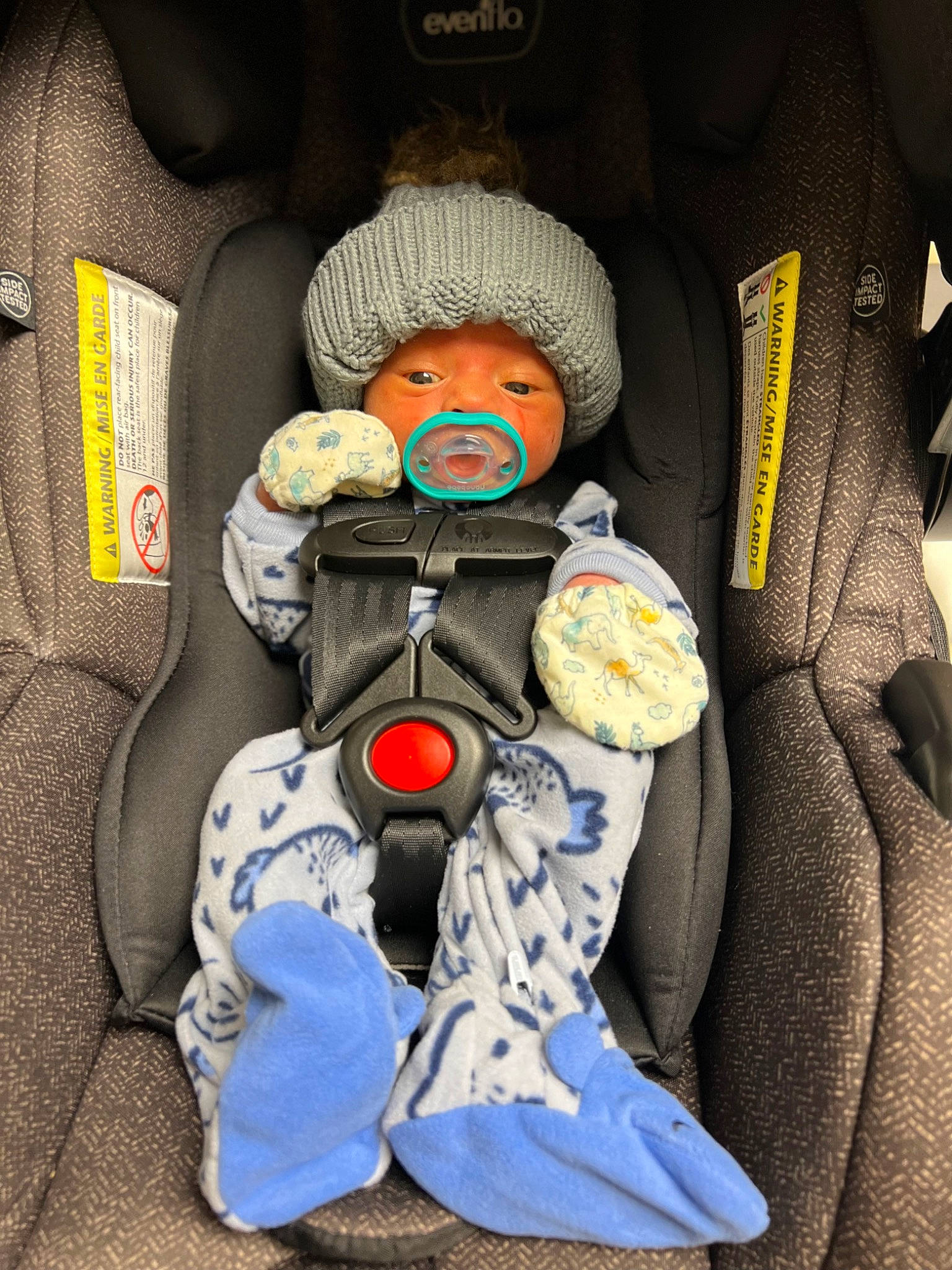 Malachi is registered to the contest to win money with this photo: auto_part, baby, baby_carriage, baby_in_car_seat, baby_products, baby_safety, baby_sleeping, baby_toddler_clothing, car_seat, car_seat_cover, child, comfort, electric_blue, head_restraint, headwear, motor_vehicle, person, personal_protective_equipment, product, seat_belt