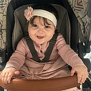 Harper-Mae joined the competition — help win amazing prizes! baby, child, smiling, stroller, headband, flower, pink, blanket, clothing, seatbelt, hands, infant, cute, portrait, indoors, happy, person, baby_girl, cushion, fabric