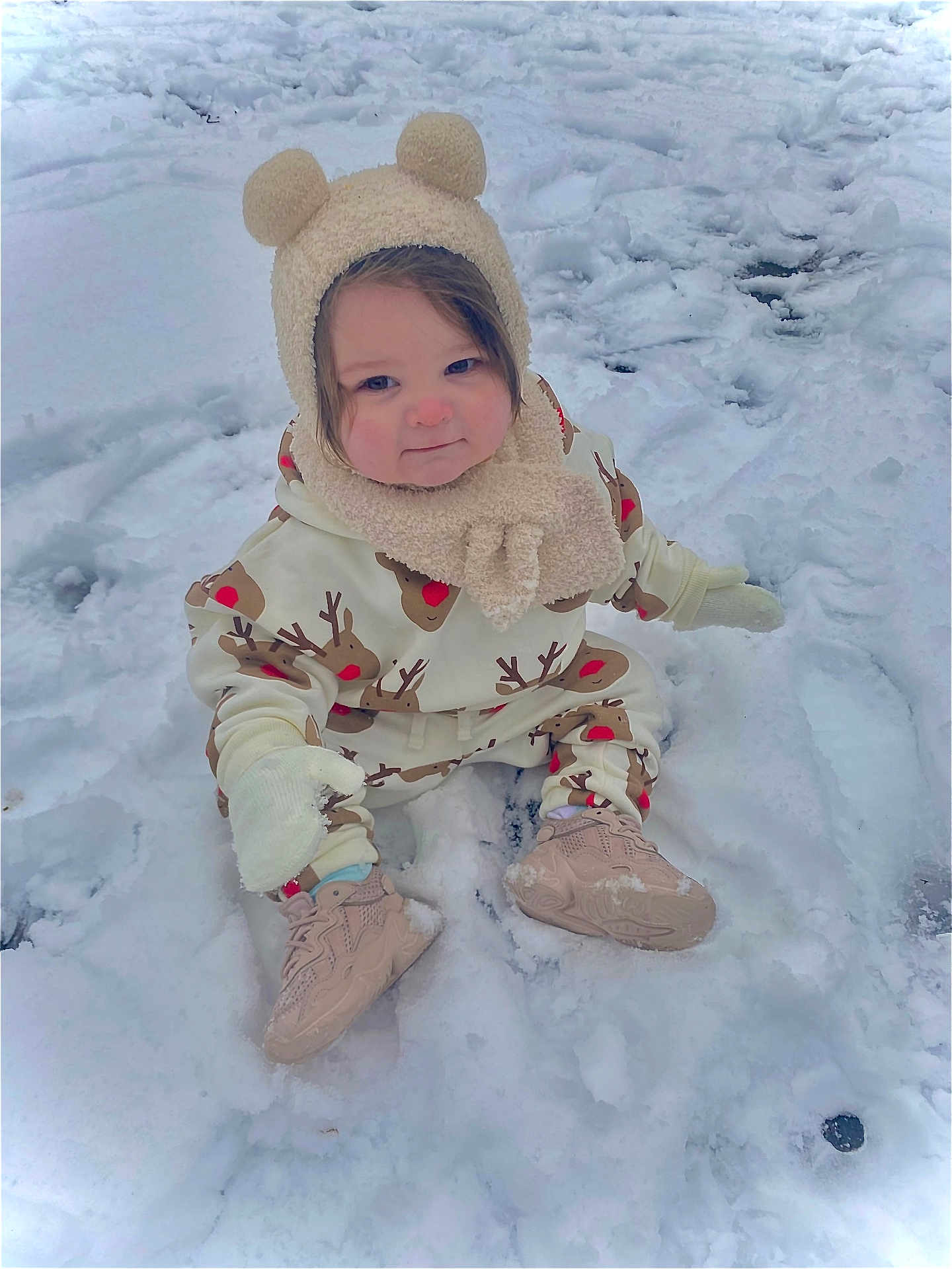 Harper-Mae joined the competition — help win amazing prizes! toddler, child, snow, winter_clothing, hat, mittens, shoes, outdoor, cute, cold_weather, sitting, reindeer_pattern, playful, winter, face, person, young_child, smile, rosy_cheeks, snowy_background