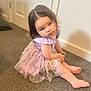 Harper-Mae joined the competition — help win amazing prizes! toddler, child, dress, lavender, floral, carpet, indoor, sitting, barefoot, cute, portrait, young_child, person, floor, curly_hair, expression, looking_up, soft_lighting, home, casual