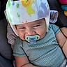 Alonzo joined the competition — help win amazing prizes! baby, infant, child, car_seat, helmet, pacifier, striped_clothing, sleepy, serious_expression, portrait, face, sitting, vehicle, car_interior, toy, colorful, close_up, indoors, safe, photography