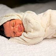 Ayzel is registered to the contest to win money with this photo: baby, bed, blanket, child, comfort, cozy, cute, face, head, infant, newborn, peaceful, portrait, resting, skin, sleeping, smile, soft, warm, wrapped