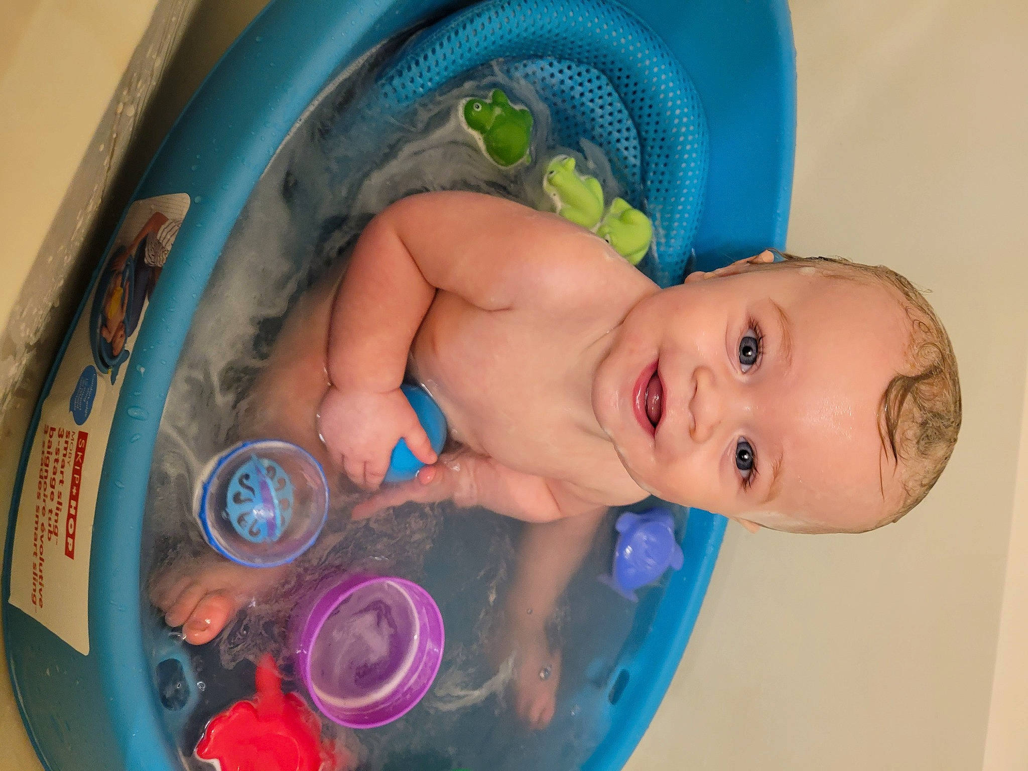 Tate is registered to the contest to win money with this photo: baby, baby_bathing, baby_products, baby_safety, bathing, bathroom, bathtub, blue, cheek, chest, child, circle, electric_blue, fluid, fun, joy, leisure, liquid, person, skin