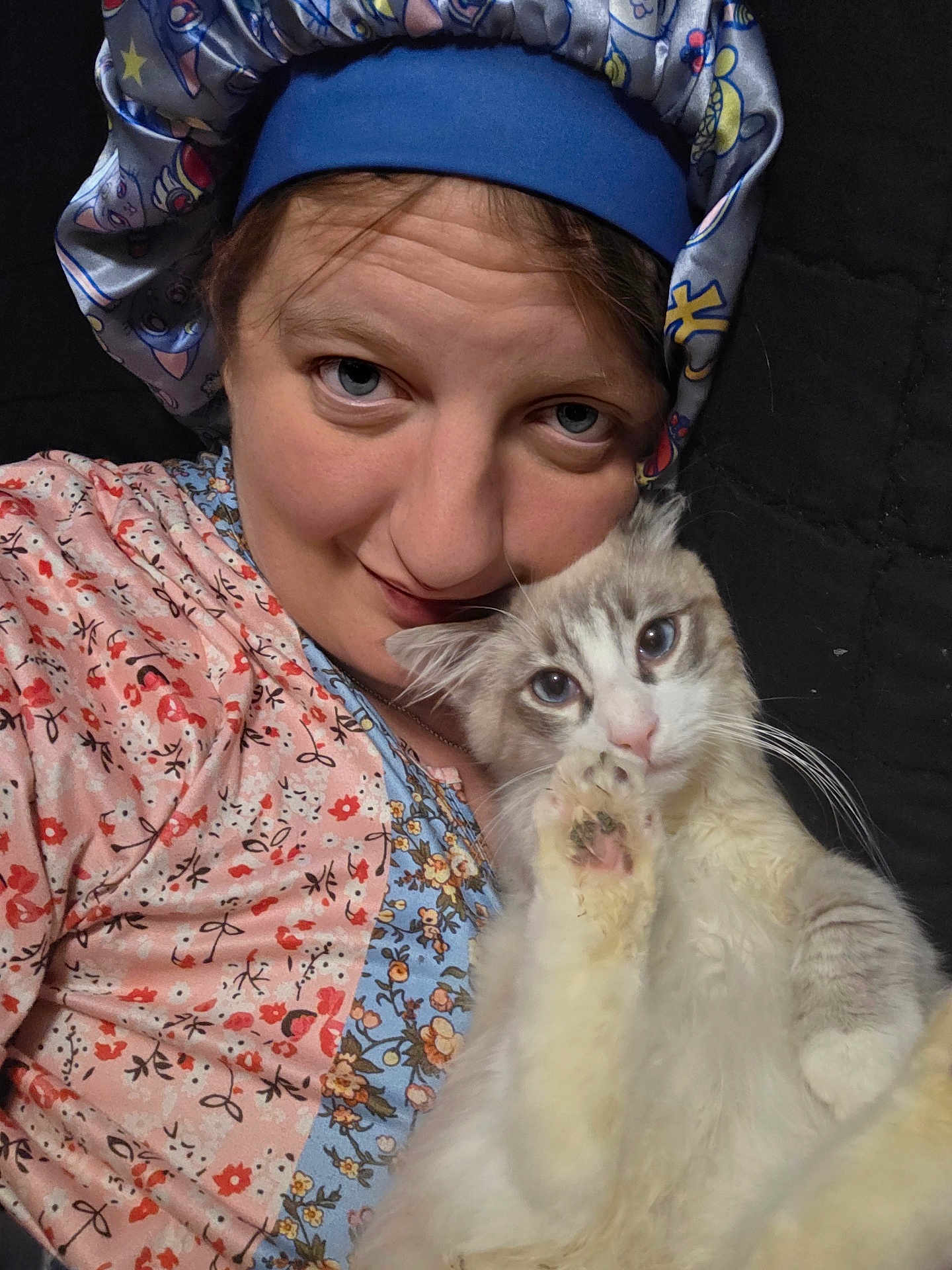Geralt is registered to the contest to win money with this photo: animal, bedtime, cat, closeup, cozy, cute, face, fluffy_cat, friendship, headwear, human, indoor, patterned_clothing, paw, person, pet, portrait, relaxed, selfie, smiling