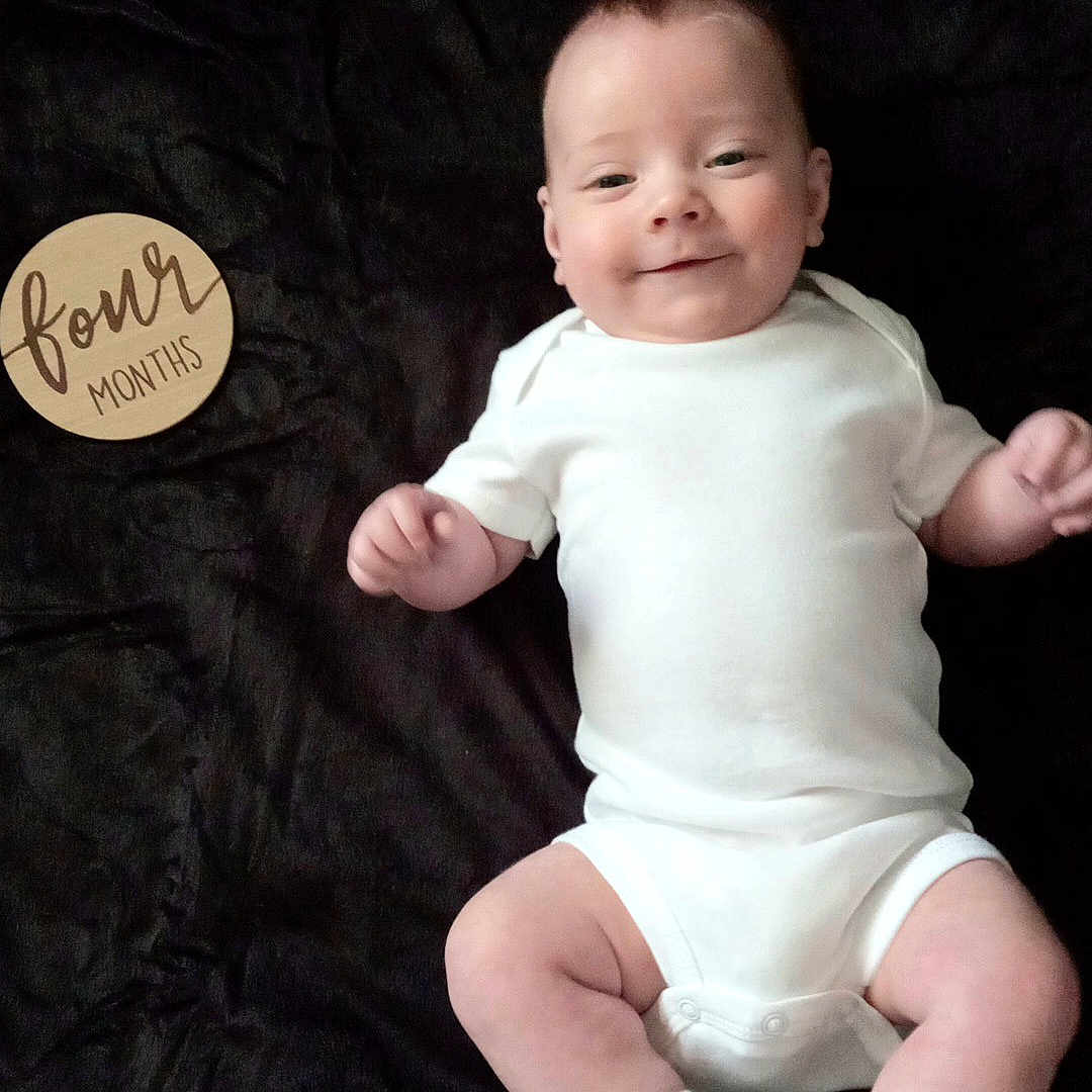 Kevin joined the competition — help win amazing prizes! baby, bodypart, clothing, diaper, face, finger, glove, hand, happy, head, hosiery, laughing, newborn, person, photography, portrait, sitting, smile, sock, t_shirt