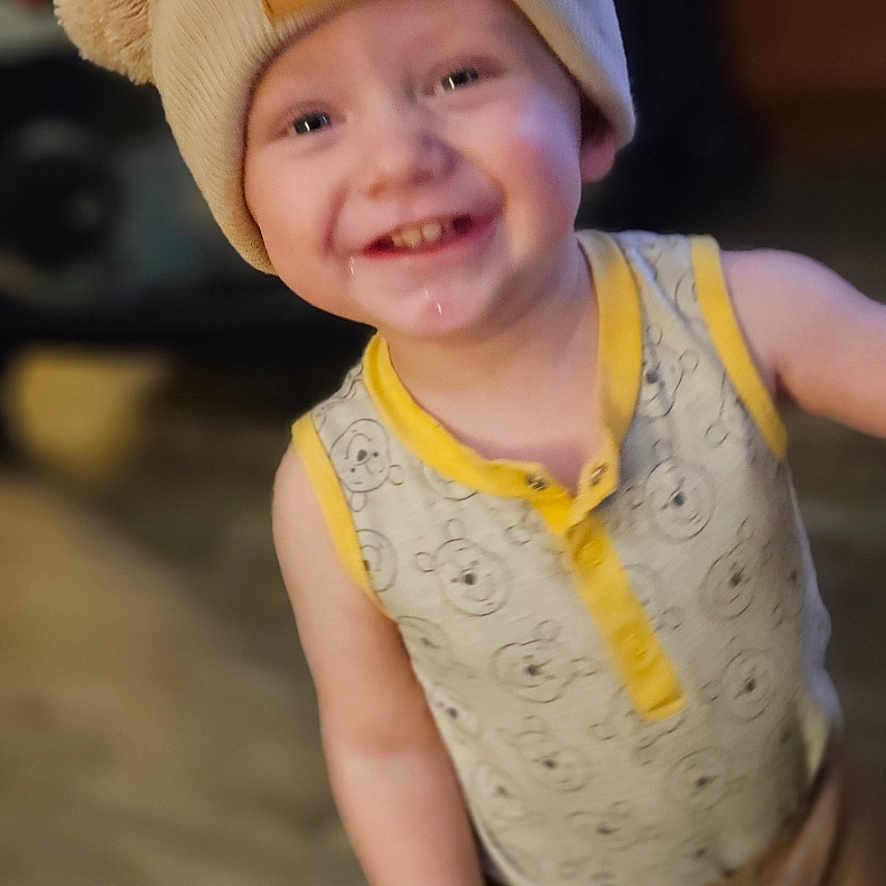 Bentlee is registered to the contest to win money with this photo: baby, beanie, bodypart, bonnet, cap, clothing, costume, face, finger, hand, happy, hat, head, laughing, pants, person, photography, portrait, smile, wood