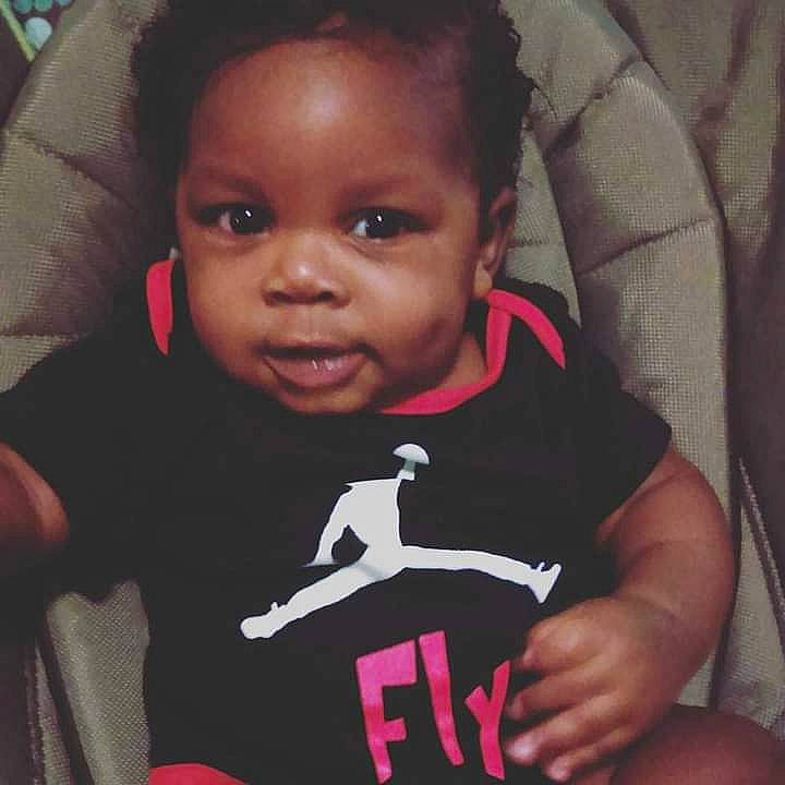 David is registered to the contest to win money with this photo: arm, baby, baby_toddler_clothing, cheek, cool, ear, eyelash, finger, forehead, hair, hand, happy, lip, mammal, mouth, nose, person, sleeve, smile, t_shirt