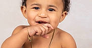 Akon is registered to the contest to win money with this photo: accessories, arm, baby, babylaughing, biting, bodypart, face, finger, hair, hand, happy, head, jewelry, necklace, pendant, person, photography, portrait, shoulder, smile