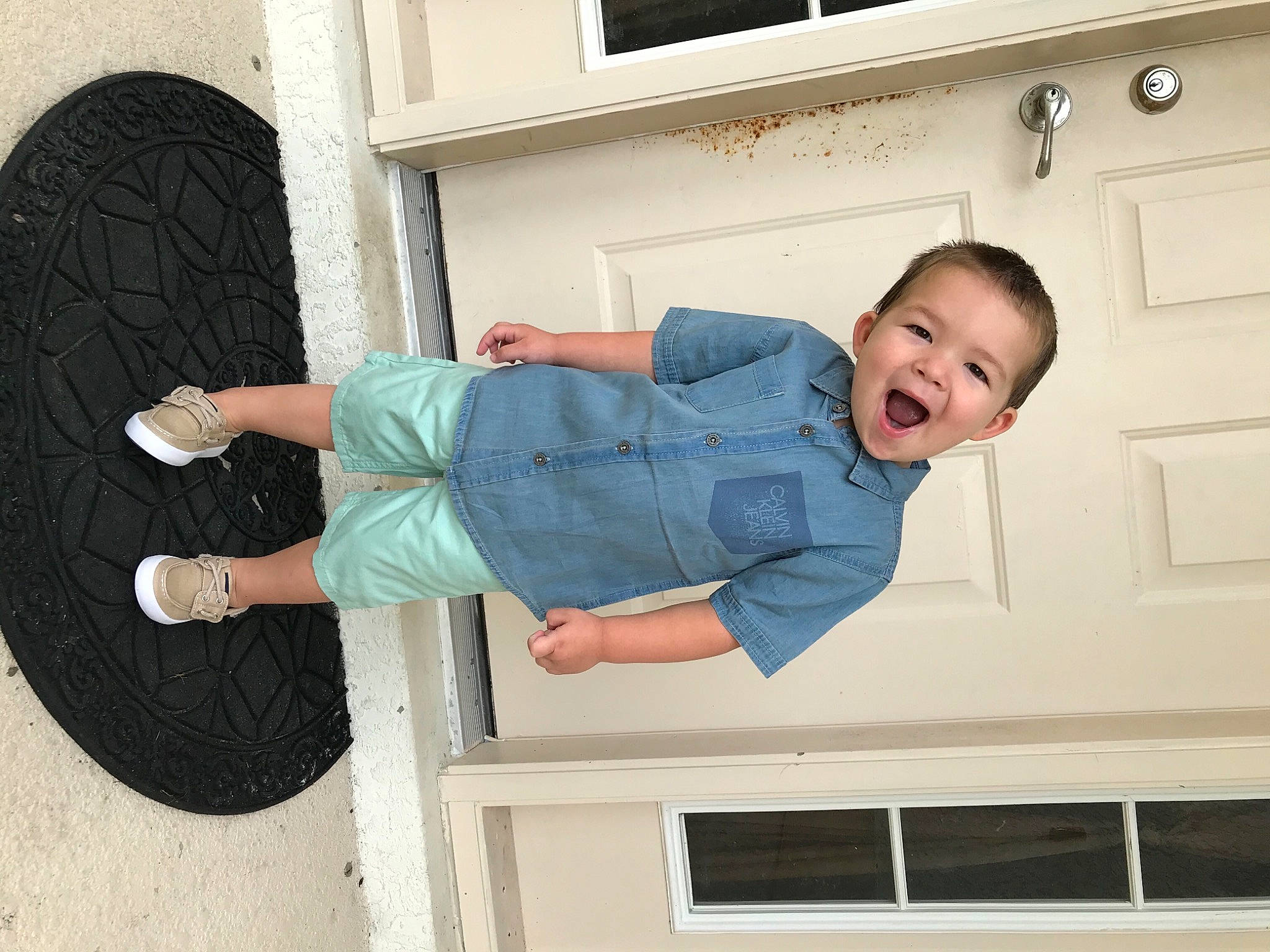 Jayce joined the competition — help win amazing prizes! baby_toddler_clothing, comfort, denim, door, elbow, electric_blue, fun, happy, pattern, person, product, sitting, sleeve, smile, t_shirt, thigh, toddler, walking_shoe, window, wood
