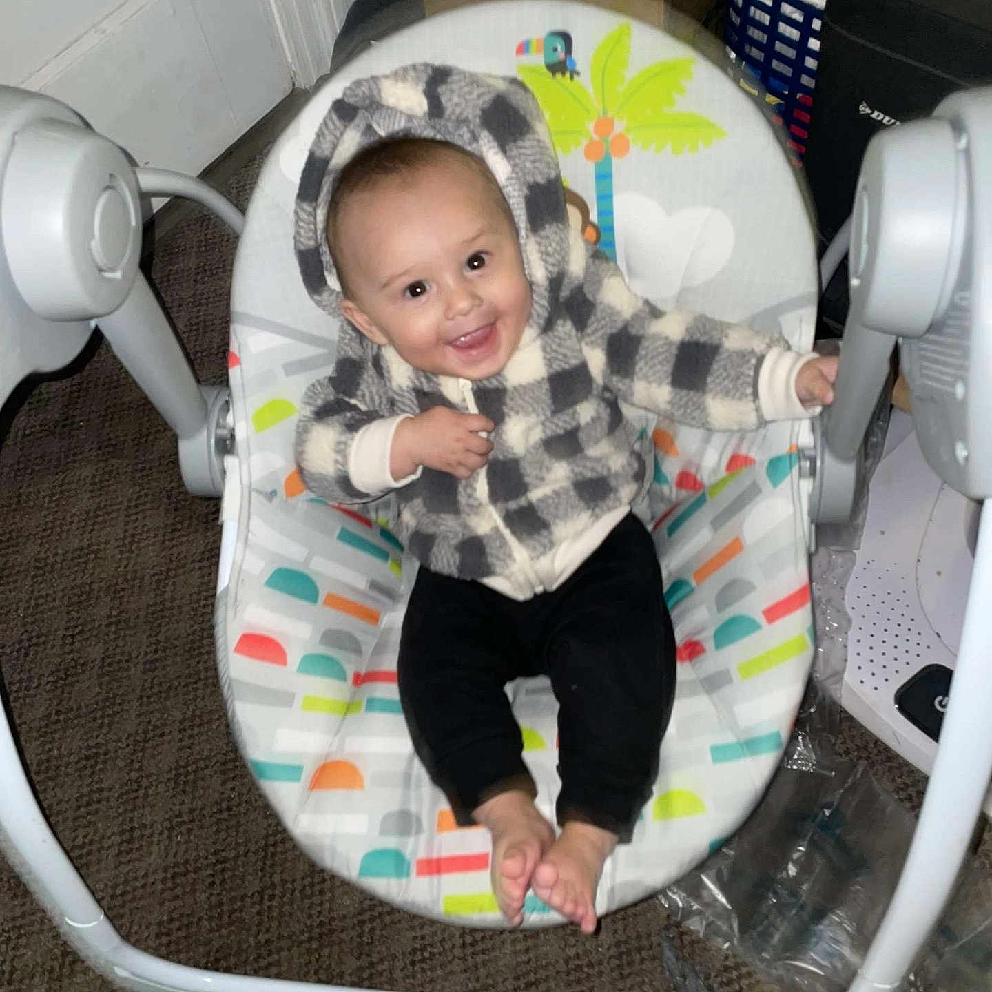 Andrae is registered to the contest to win money with this photo: baby, babylaughing, blanket, clothing, crib, cushion, cutlery, face, furniture, happy, head, homedecor, infantbed, pants, person, photography, portrait, sitting, smile, spoon