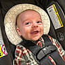 Kayden is registered to the contest to win money with this photo: baby, infant, car_seat, smiling, happy, child, plaid_clothing, safety_harness, headrest, indoor, closeup, cute, person, seatbelt, car, portrait, young_child, cheerful, secured, infant_clothing