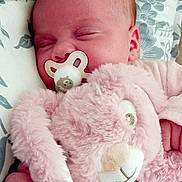 Charlotte participe au concours pour gagner de l'argent avec cette photo : baby, bed, child, closeup, cozy, cute, face, floral_pattern, hand, infant, newborn, pacifier, peaceful, pillow, pink, plush, resting, sleeping, soft_toy, stuffed_animal
