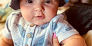 Jett joined the competition — help win amazing prizes! baby, infant, hat, bucket_hat, onesie, button_up, whale_pattern, hand, pink_nail_polish, face, eyes, cheeks, indoor, warm_lighting, person, portrait, cute, child, clothing, holding