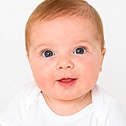 Parker joined the competition — help win amazing prizes! baby, infant, child, face, blue_eyes, white_onesie, close_up, portrait, cute, smiling, skin, head, young, childhood, innocence, human, person, expression, studio, background