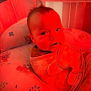Koltyn joined the competition — help win amazing prizes! baby, infant, blanket, cushion, baby_seat, face, person, indoor, red_lighting, clothing, cute, child, portrait, soft_furniture, head, expression, young, cozy, comfort, wrapped