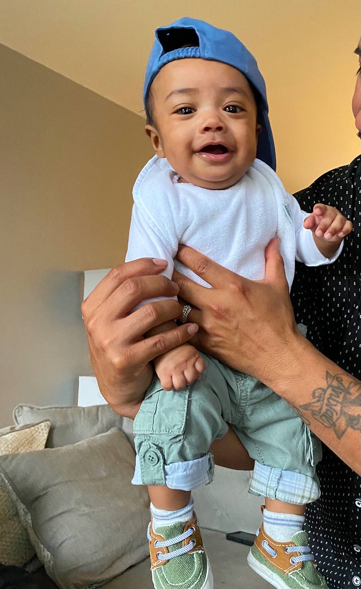 Micah is registered to the contest to win money with this photo: baby, baby_toddler_clothing, cap, cheek, child, finger, fun, gesture, hand, happy, headwear, human_body, nail, person, pink, skin, sleeve, sock, thumb, toddler