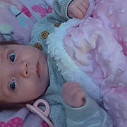 Aurora is registered to the contest to win money with this photo: baby, blanket, pacifier, infant, soft_texture, pink, gray_clothing, hand, face, wide_eyes, fabric, cute, newborn, lying_down, indoor, cozy, child, warm, comfort, portrait