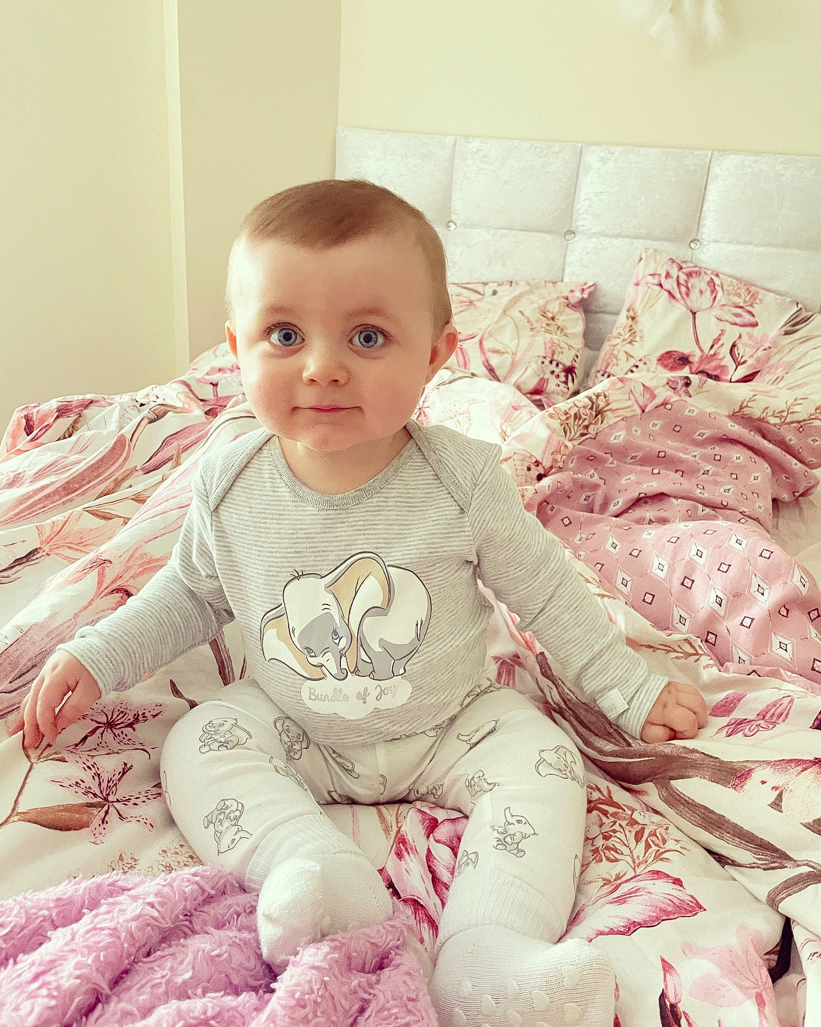 Casey is registered to the contest to win money with this photo: arm, baby, baby_toddler_clothing, cheek, child, comfort, dress, face, hand, happy, human_body, iris, lip, mouth, pattern, person, pink, skin, sleeve, t_shirt