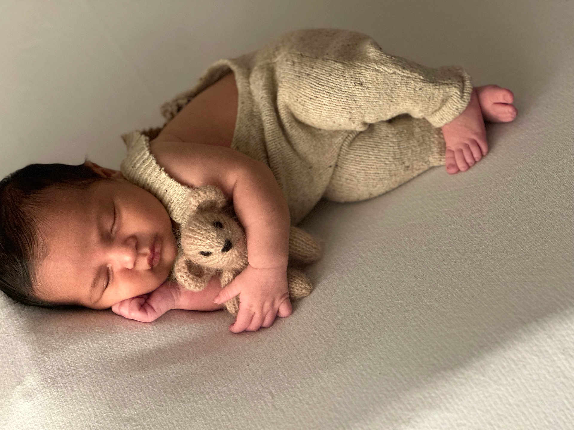 Alonzo joined the competition — help win amazing prizes! baby, sleeping, teddy_bear, knitwear, infant, cozy, soft_light, peaceful, newborn, cute, cuddling, child, portrait, fingers, toes, fabric, resting, indoors, closeup, warm
