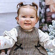 Willow joined the competition — help win amazing prizes! toddler, child, smiling, portrait, pigtails, plaid_dress, white_blouse, arms_outstretched, happy, indoors, christmas_tree, snow, holiday, decorations, face, cute, winter, closeup, person, festive