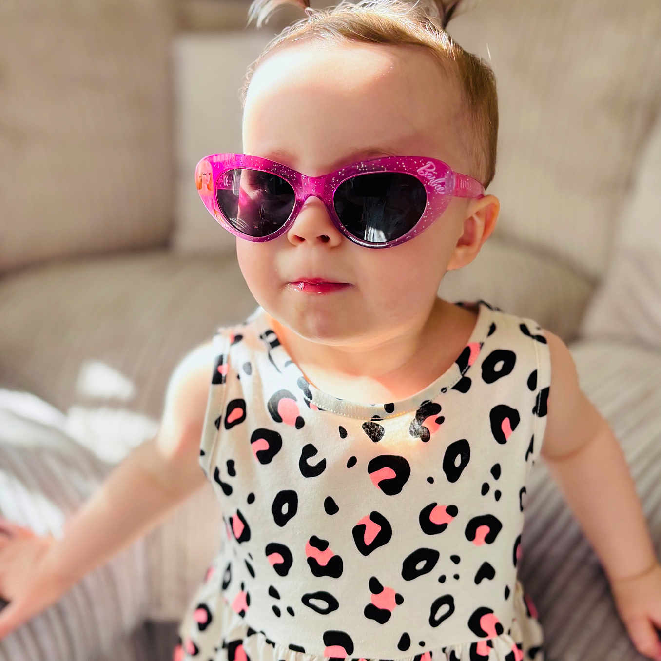 Grace Louise joined the competition — help win amazing prizes! barbie, child, clothing, couch, cute, dress, fashion, hair, indoor, leopard_print, person, pigtails, pink, portrait, seated, smile, sunglasses, sunlight, toddler, young