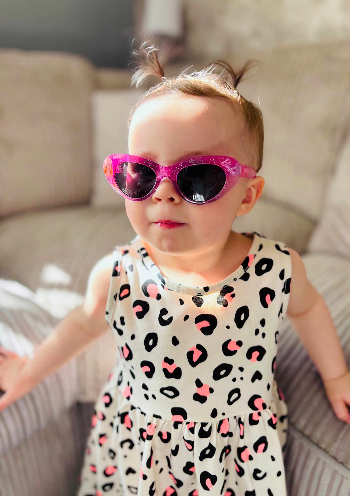 Grace Louise joined the competition — help win amazing prizes! toddler, child, sunglasses, pink, barbie, leopard_print, dress, pigtails, couch, indoor, sunlight, cute, fashion, portrait, smile, person, clothing, hair, young, seated