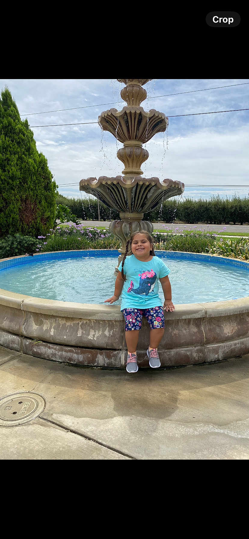 Adalyn is registered to the contest to win money with this photo: architecture, child, clothing, face, female, footwear, fountain, girl, head, person, photography, plant, pool, portrait, pottedplant, shoe, shorts, summer, swimmingpool, water