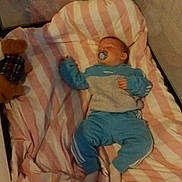 Ronnie Oliver joined the competition — help win amazing prizes! baby, sleeping, crib, blanket, pacifier, teddy_bear, blue_clothing, pink_stripes, cozy, infant, child, soft_toy, resting, indoors, bedtime, cute, comfort, peaceful, sleepwear, nursery