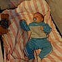 baby, sleeping, crib, blanket, pacifier, teddy_bear, blue_clothing, pink_stripes, cozy, infant, child, soft_toy, resting, indoors, bedtime, cute, comfort, peaceful, sleepwear, nursery