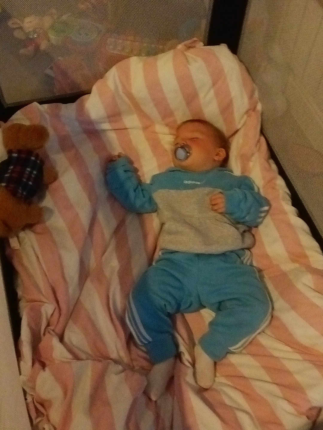 Ronnie Oliver joined the competition — help win amazing prizes! baby, sleeping, crib, blanket, pacifier, teddy_bear, blue_clothing, pink_stripes, cozy, infant, child, soft_toy, resting, indoors, bedtime, cute, comfort, peaceful, sleepwear, nursery