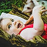Lily participe au concours pour gagner de l'argent avec cette photo : baby, baby_hand, child, cute, eyes, face, greenery, happy, infant, laying, nature, outdoor, playful, portrait, red_clothing, skin, smile, tree, wood, young_child