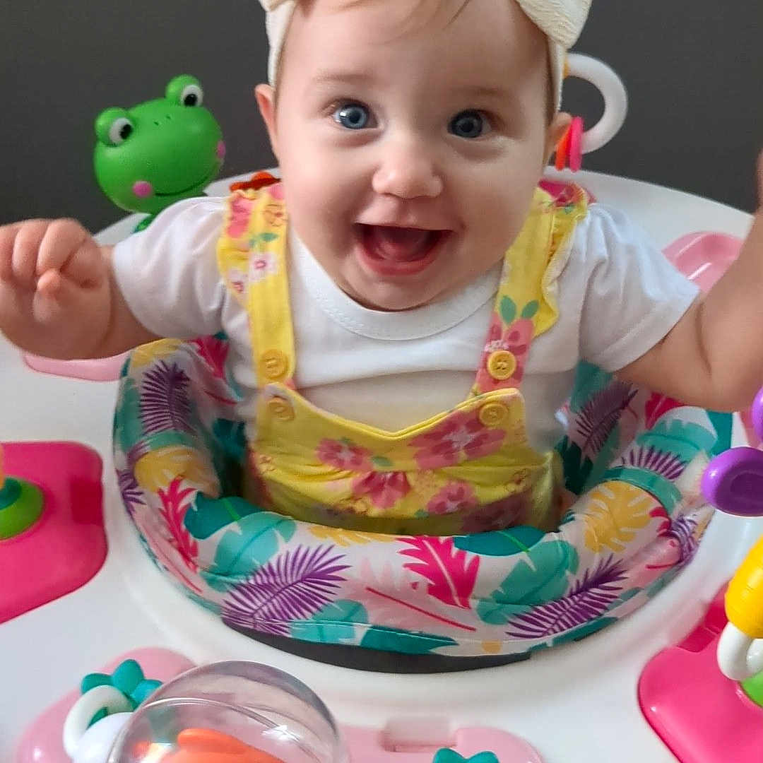 Lilly is registered to the contest to win money with this photo: baby, bodypart, cap, clothing, cream, cutlery, dessert, face, food, furniture, happy, hat, head, icing, person, photography, portrait, smile, spoon, toy