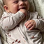 baby, infant, smiling, onesie, horse_pattern, blanket, cozy, hand, face, cheerful, soft_texture, child, cute, lying_down, happy, young_child, clothing, comfort, indoor, portrait