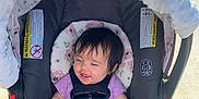 Elisá joined the competition — help win amazing prizes! baby, car_seat, child, cute, flower_pattern, footwear_free, grass, happy, infant, nature, outdoor, person, purple_clothing, safety_harness, seat, sidewalk, smiling, stroller, sunlight, toddler