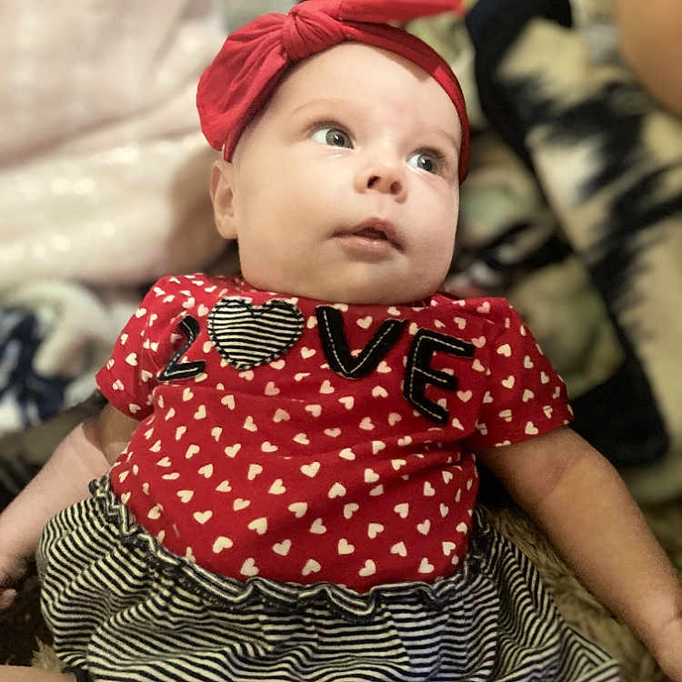Shelby joined the competition — help win amazing prizes! accessories, baby, bodypart, bonnet, cap, clothing, couch, face, finger, furniture, hand, happy, hat, head, headband, person, photography, portrait, sitting, smile