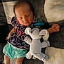 baby, sleeping, plush_toy, pacifier, blanket, infant, clothing, cute, patterned_outfit, lying_down, cozy, soft_toy, small_child, indoors, resting, peaceful, child, fabric, nap, comfort