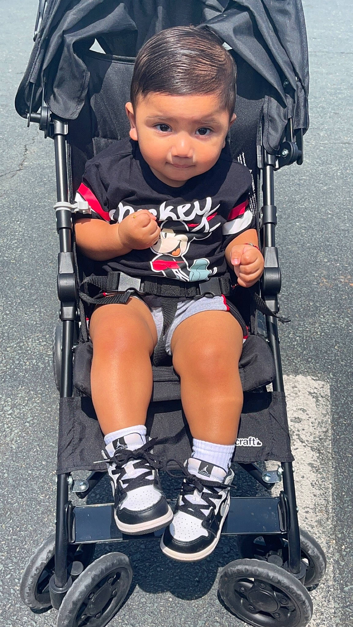 Julian is registered to the contest to win money with this photo: baby, baby_carriage, baby_products, chair, comfort, electric_blue, eye, human_leg, lap, leg, person, photograph, product, shorts, sitting, snapshot, thigh, tire, toddler, wheel