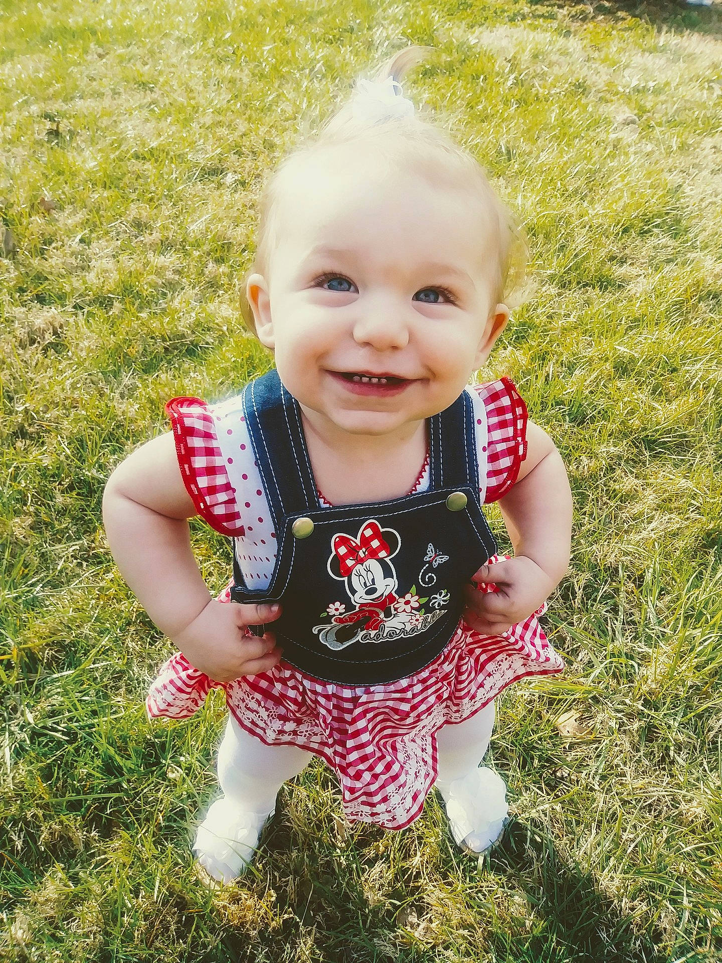 Nakota is registered to the contest to win money with this photo: child, day, facial_expression, fun, girl, grass, happiness, infant, joy, lawn, pattern, person, pink, plaid, plant, play, product, skin, smile, summer