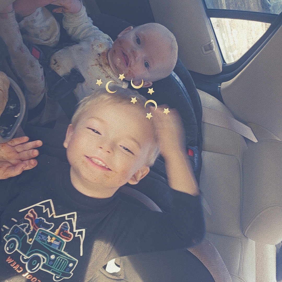 Nixon is registered to the contest to win money with this photo: baby, blond_hair, car_seat, car_window, child, clothing, cute, graco, happy, indoors, infant, messy_face, playful, portrait, safety, seat, seatbelt, smiling, toddler, vehicle_interior