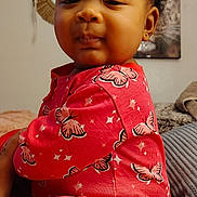 Camelle joined the competition — help win amazing prizes! child, baby, toddler, pajamas, butterfly_pattern, curly_hair, earring, blanket, bed, indoor, portrait, close_up, cozy, sleepy_expression, pink_clothing, soft_texture, wall_art, decor, string_lights, person