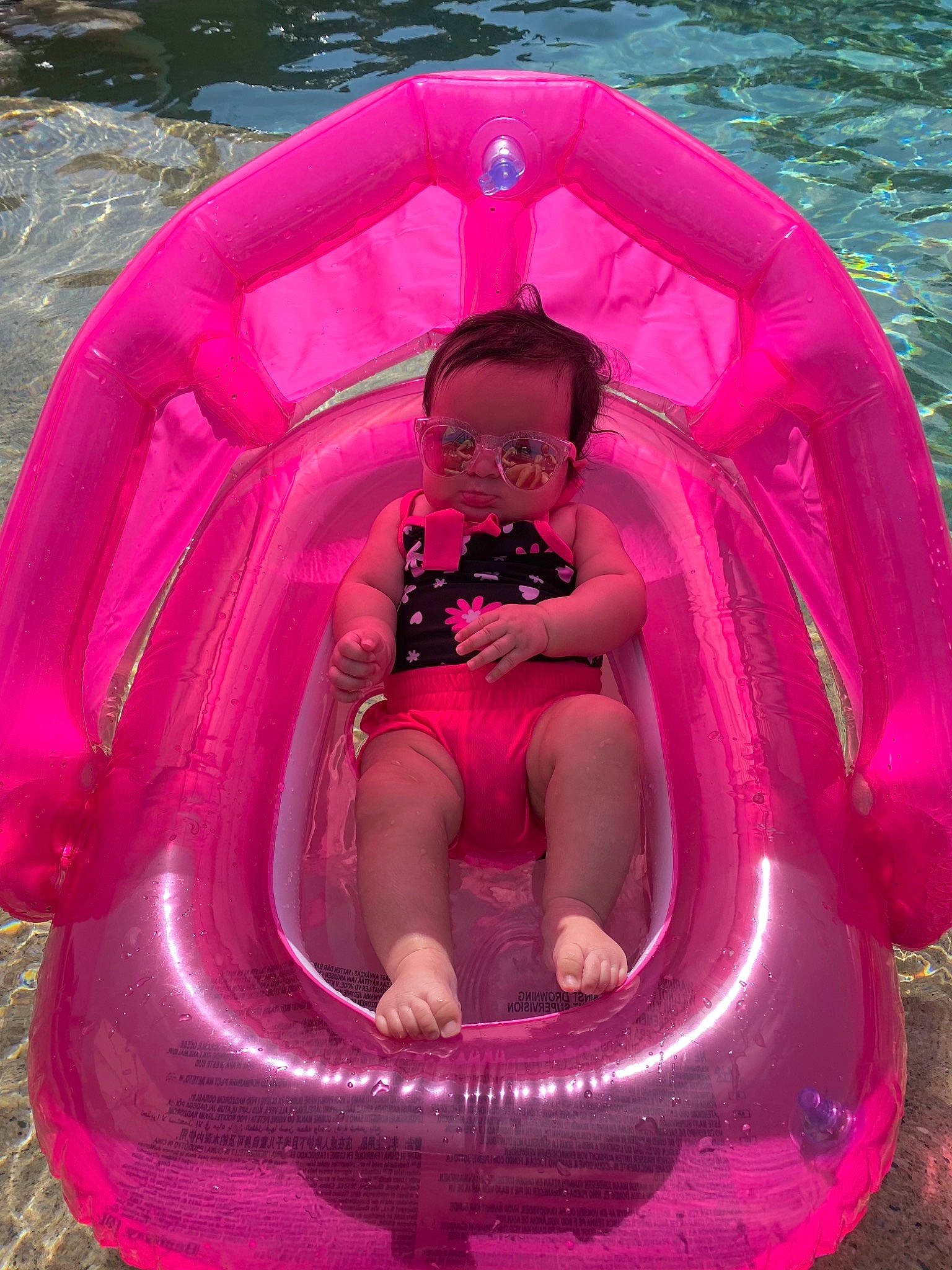 Samari is registered to the contest to win money with this photo: baby, baby_carriage, baby_products, baby_toddler_clothing, boats_and_boating_equipment_and_supplies, child, circle, comfort, fun, grass, inflatable, leisure, magenta, person, personal_protective_equipment, pink, recreation, red, sitting, toddler