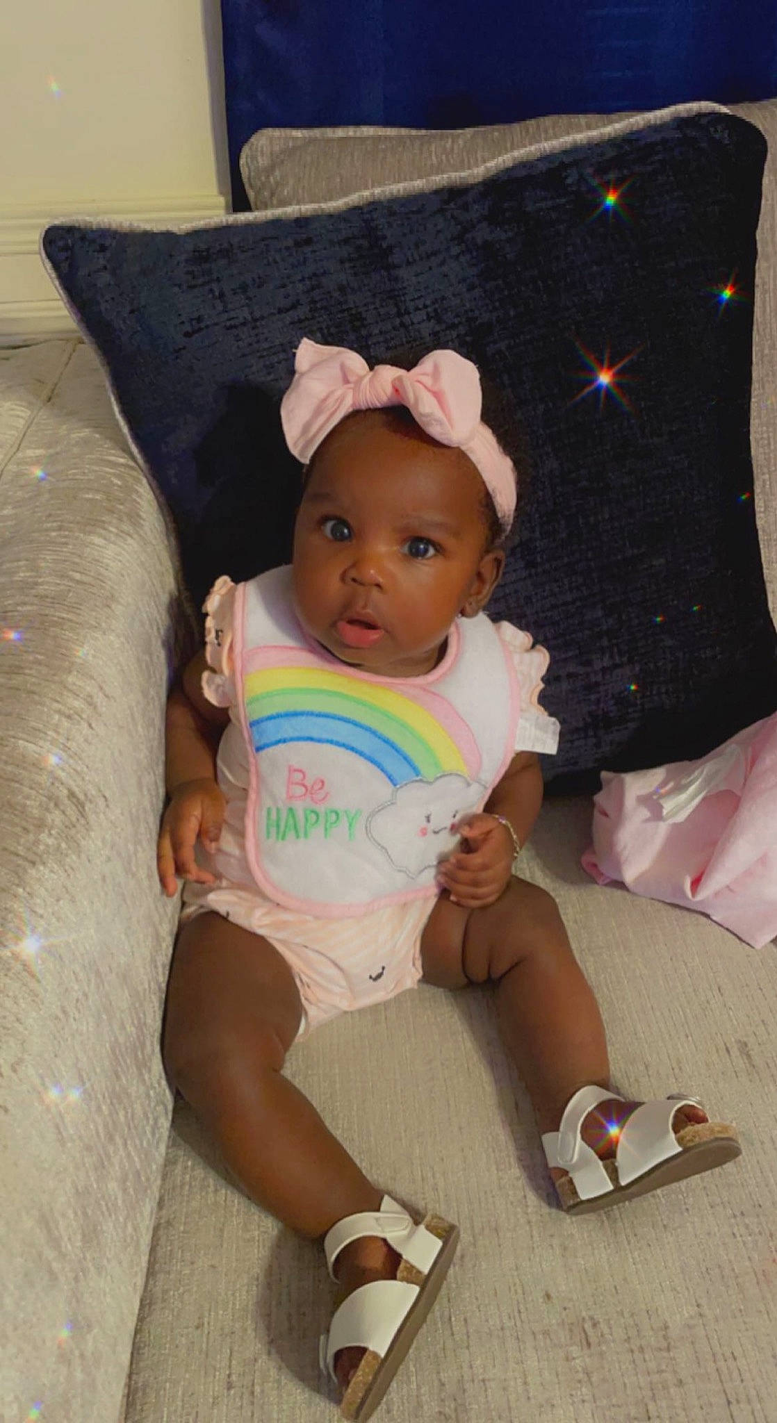 Cali joined the competition — help win amazing prizes! baby, baby_products, baby_toddler_clothing, cheek, comfort, couch, foot, human_leg, knee, lap, linens, person, pillow, pink, room, sitting, sleeve, sock, textile, thigh