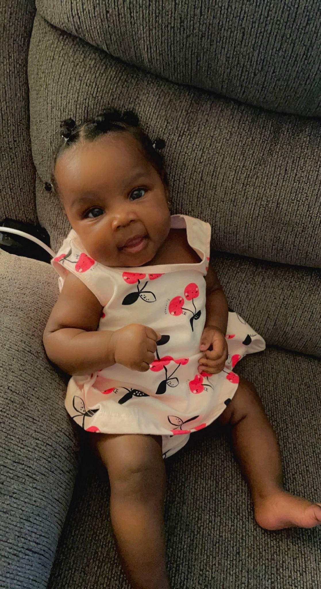 Cali is registered to the contest to win money with this photo: arm, baby, baby_toddler_clothing, cheek, dress, face, finger, hair, happy, head, iris, joint, lip, person, shoulder, skin, sleeve, smile, standing, textile