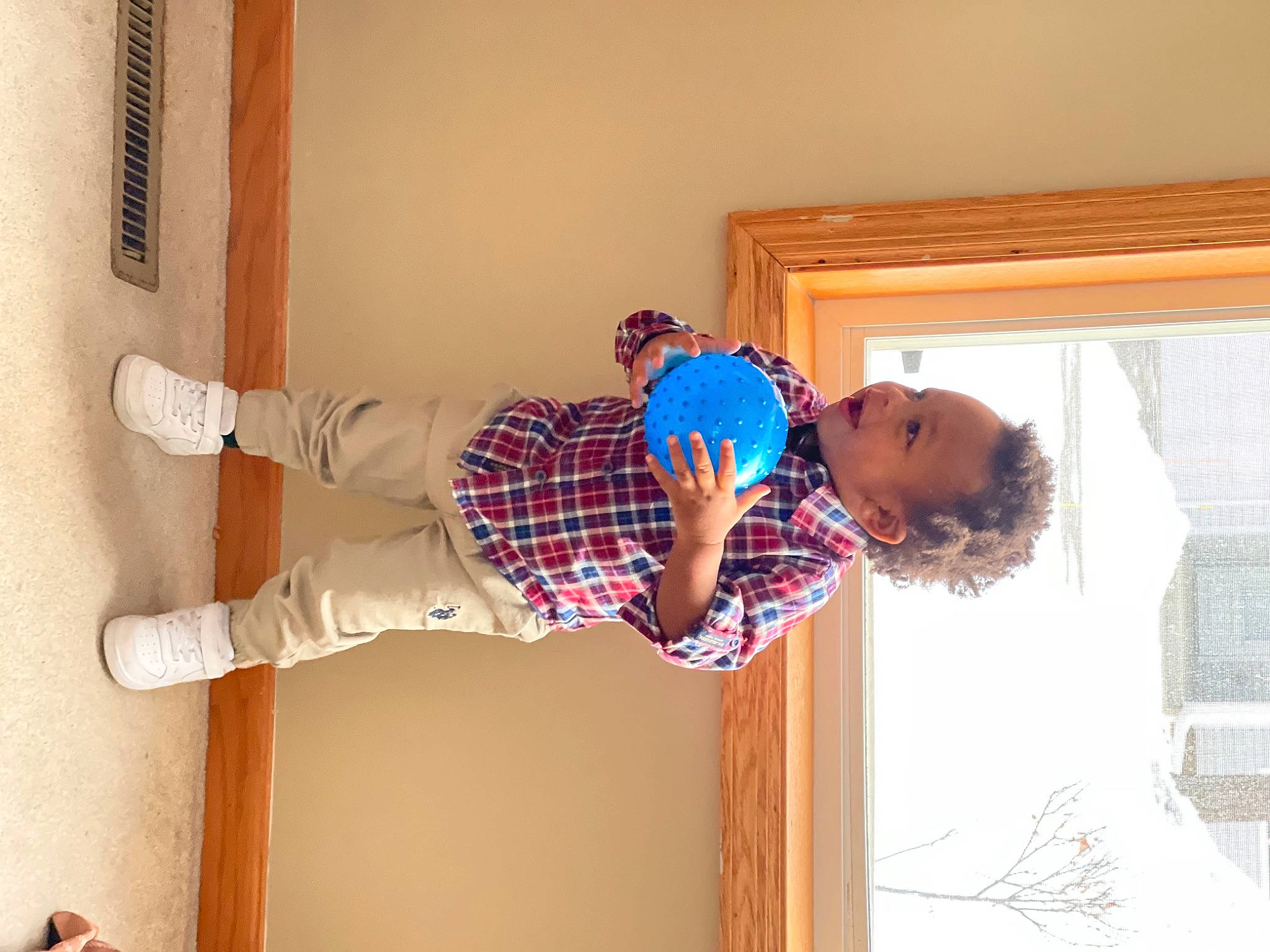 Amarion is registered to the contest to win money with this photo: baby, baby_toddler_clothing, child, comfort, flooring, fun, happy, hardwood, knee, magenta, outdoor_shoe, pattern, person, room, sock, toddler, window, wood