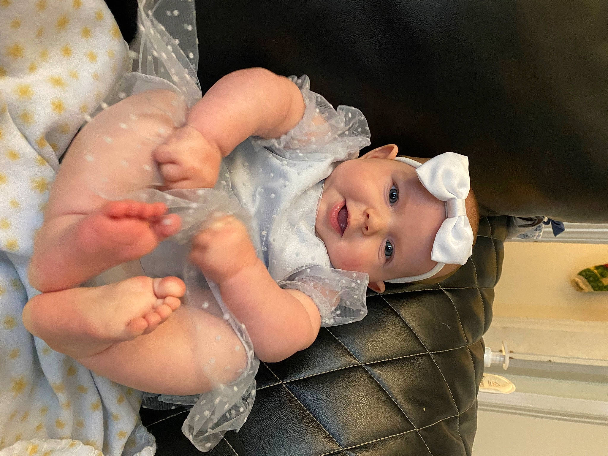 Maelynn is registered to the contest to win money with this photo: baby, baby_products, baby_toddler_clothing, cheek, child, comfort, dress, event, facial_expression, finger, gesture, happy, hat, headpiece, headwear, nail, person, product, skin, smile