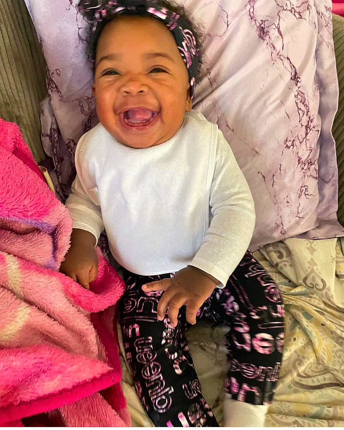 Bailey is registered to the contest to win money with this photo: baby, baby_toddler_clothing, child, cool, design, facial_expression, fashion, gesture, happy, head, magenta, pattern, person, pink, purple, skin, sleeve, smile, t_shirt, textile