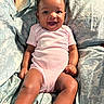 Majesti joined the competition — help win amazing prizes! baby, bedspread, child, cozy, cute, feet, furniture, hair_bows, happy, indoors, infant, legs, onesie, patterned_fabric, person, pink_clothing, portrait, sitting, skin, smiling