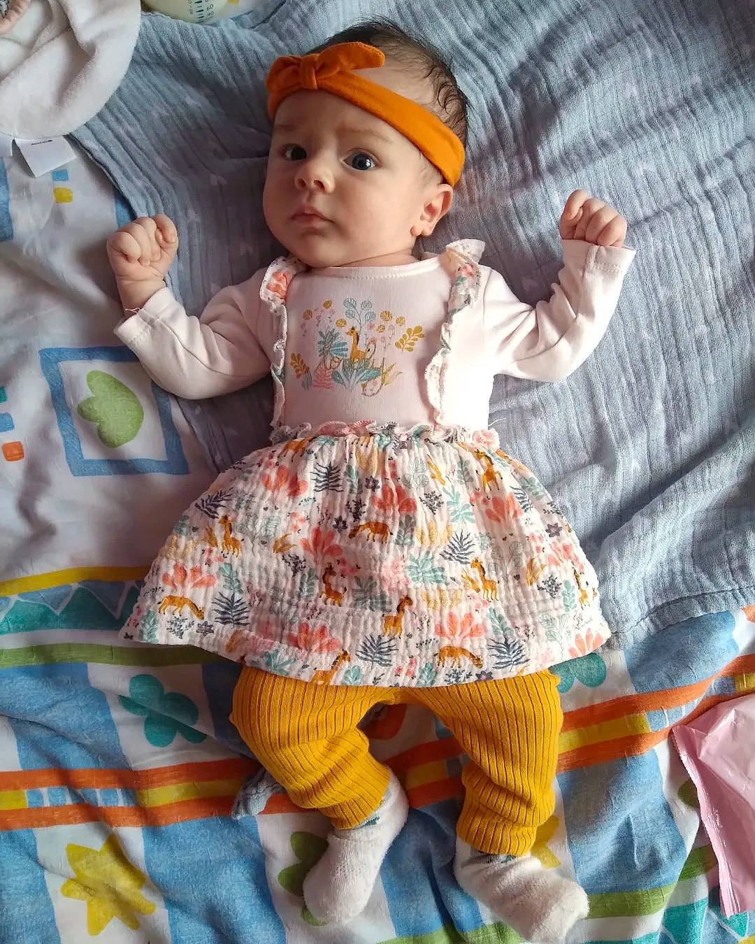 Dora participe au concours pour gagner de l'argent avec cette photo : baby, baby_products, baby_toddler_clothing, cap, child, doll, dress, face, headgear, headwear, linens, organ, outerwear, pattern, person, pink, sitting, skin, sleeve, t_shirt