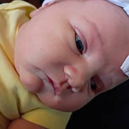 Oakleigh joined the competition — help win amazing prizes! baby, infant, face, headband, yellow_clothing, closeup, skin, expression, newborn, person, child, cute, soft_lighting, indoors, portrait, young, head, baby_girl, clothing, human